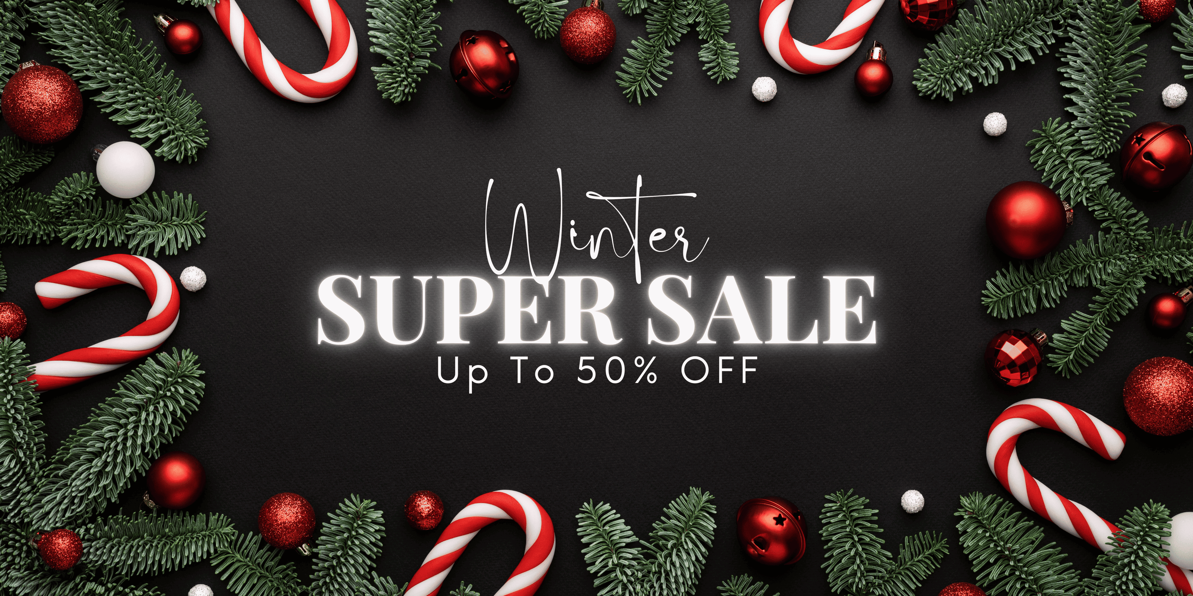 Winter Super Sale banner with text ‘Up to 50% Off’ surrounded by Christmas pine branches, red ornaments and candy canes on a dark background.