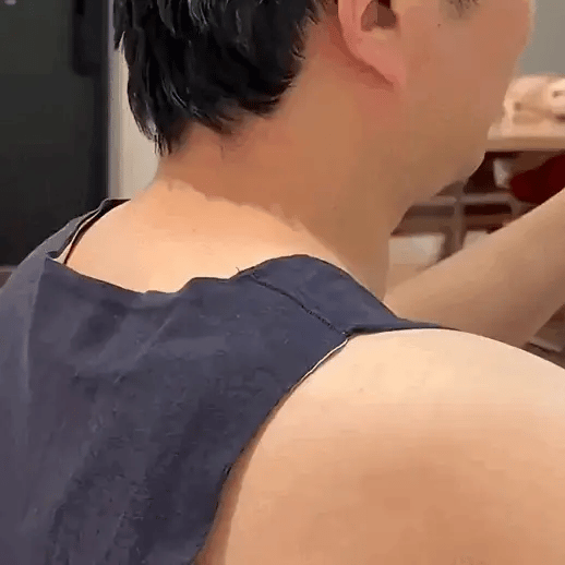 Handy Neck Massager providing strong deep kneading and heat therapy on side of neck for muscle tension relief