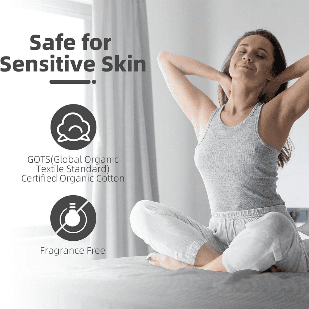 Woman in organic cotton clothing sitting on a bed with text about safe for sensitive skin and GOTS certification.