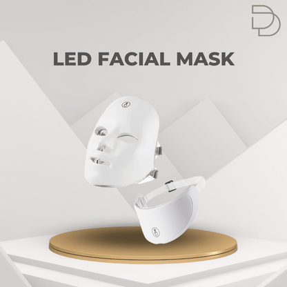 White LED facial mask on a gold stand with 'DDrelax' branding on a gray geometric background