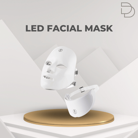 White LED facial mask on a gold stand with 'DDrelax' branding on a gray geometric background
