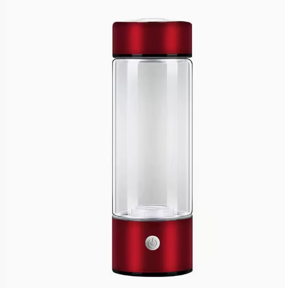 Clear glass bottle with red metal top and base on a white background