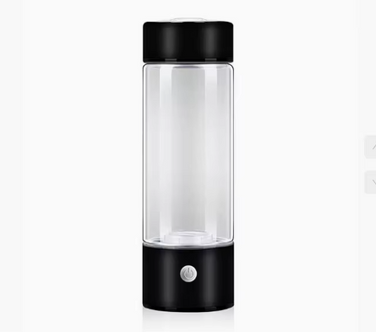 Clear glass bottle with black lid and base on a white background